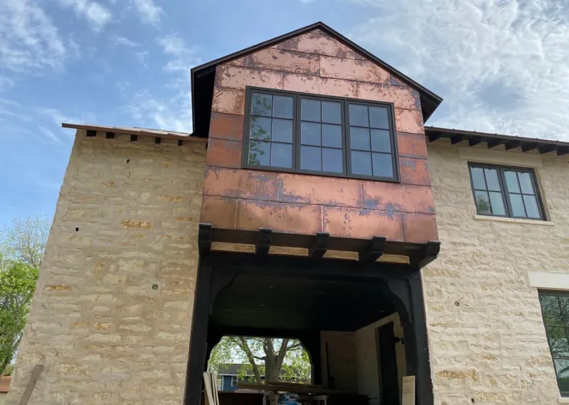 Copper metal panel facade on a stone building for Skylight Installation in Bensalem